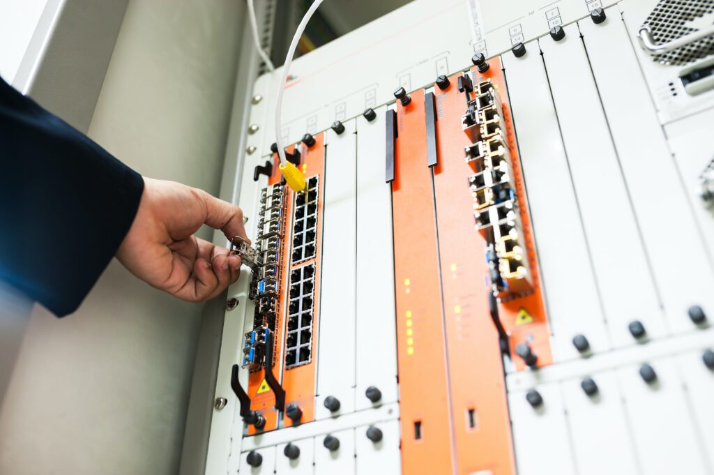 Engineer fixing core swith in data center room